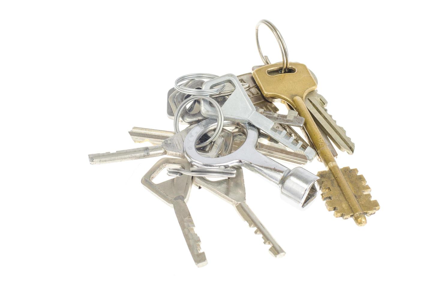 Bundles of old keys on white background. photo