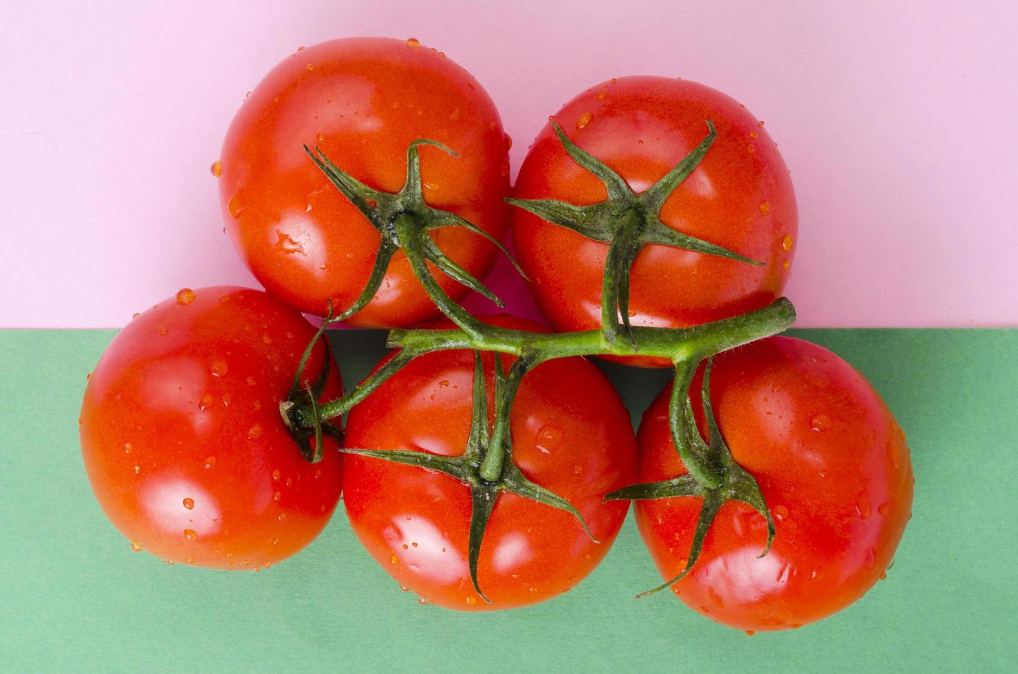 Creative layout of tomatoes on bright background. photo