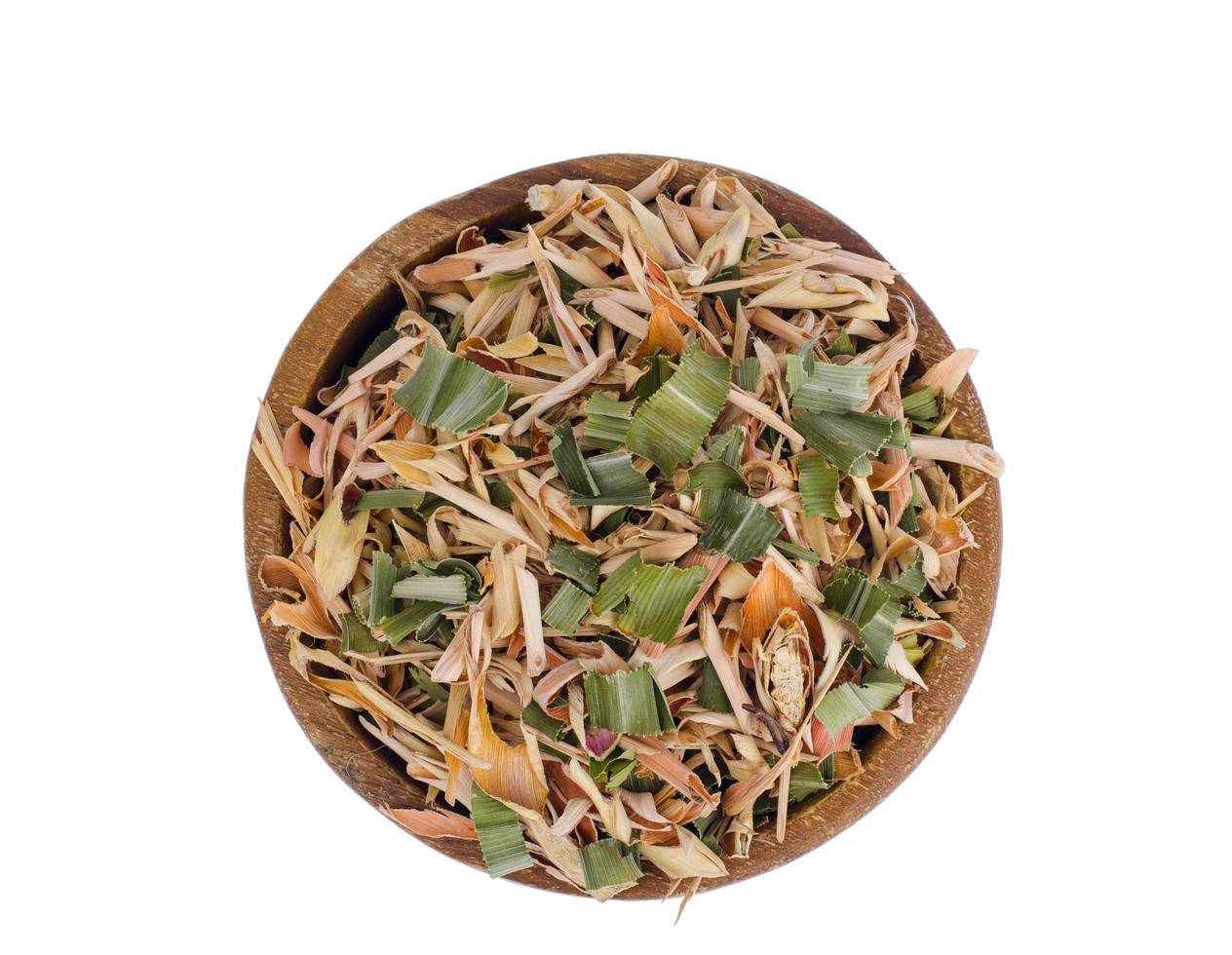 Dried lemongrass leaves in wooden bowl. photo