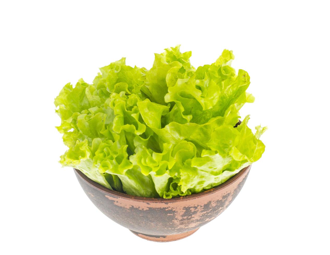 Fresh green salad leaves in clay bowl. photo