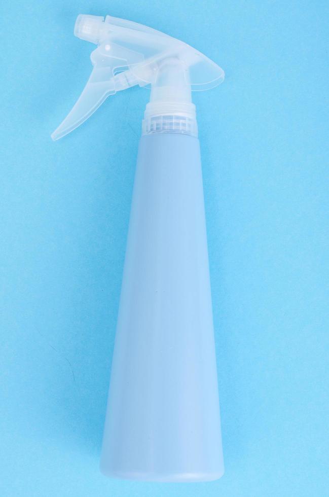 Blue bottle spray on bright background photo