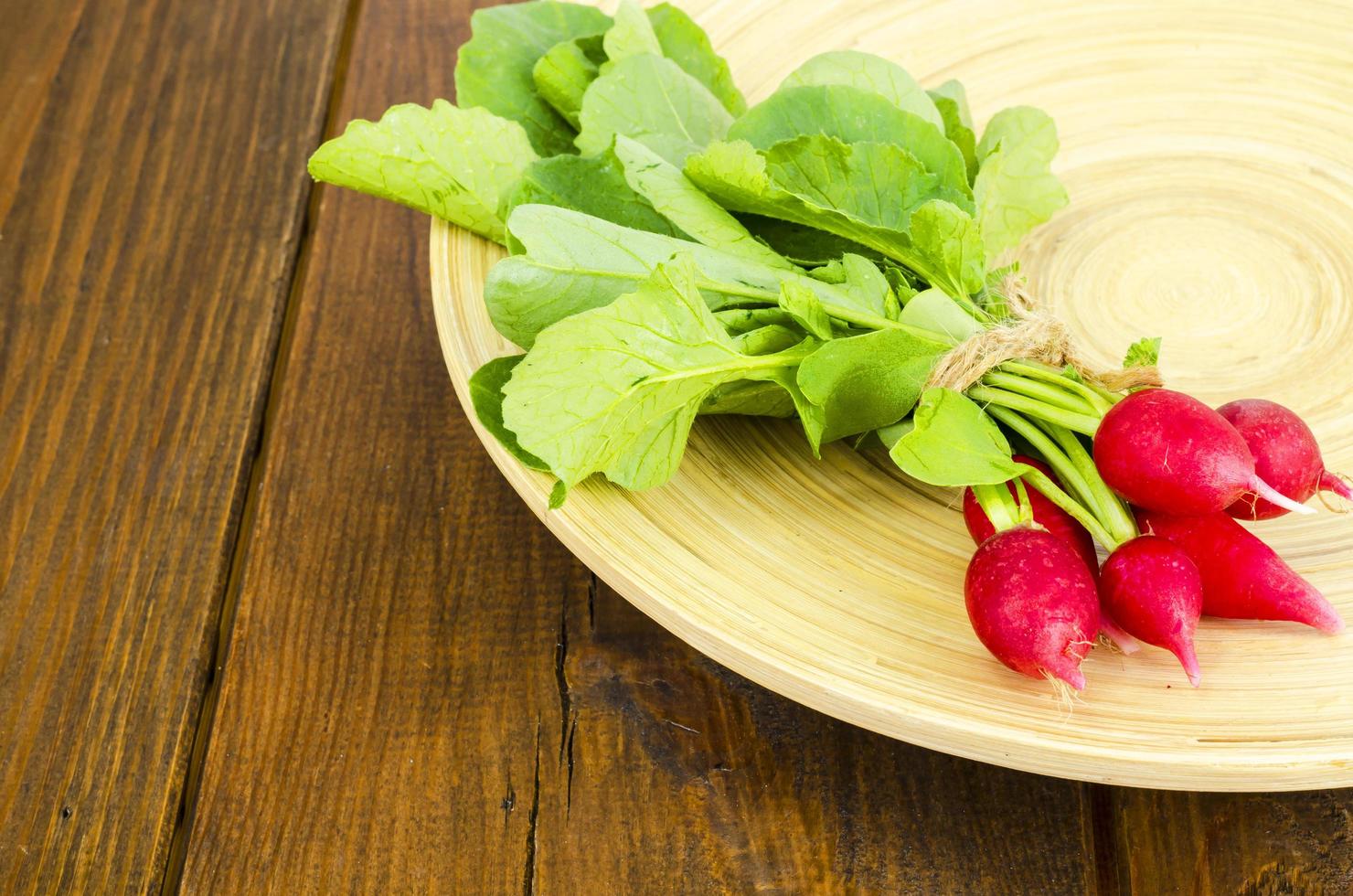 Fresh farmer bio radish on wooden plate. photo