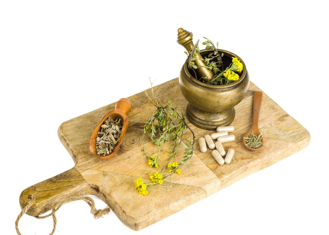 Fresh and dry shredded medicinal herbs, medical capsules. photo