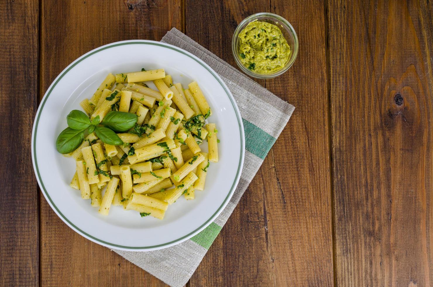 Penne pasta with pesto sauce. Italian cuisine. photo