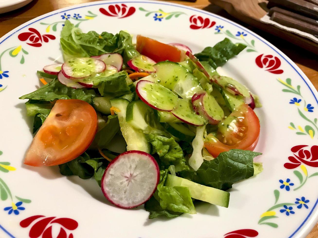 Fresh vegetable salad with green sauce. Photo