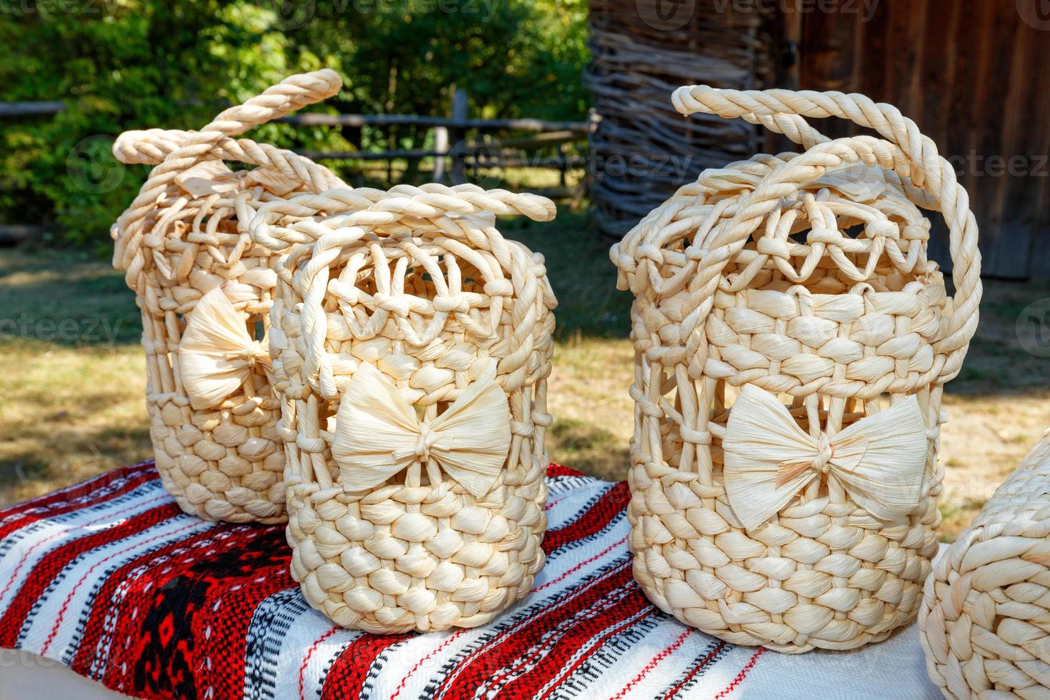 Wicker handbags made of natural bleached dried corn leaves against the backdrop of a rural