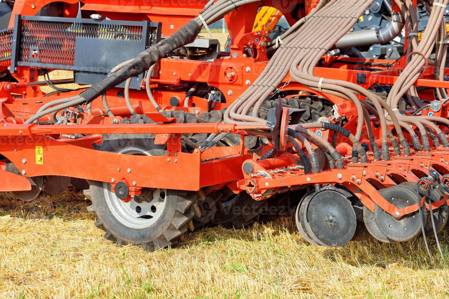 The mechanism for uniform distribution of fertilizers into the soil for a multi-row disc harrow for field work. photo