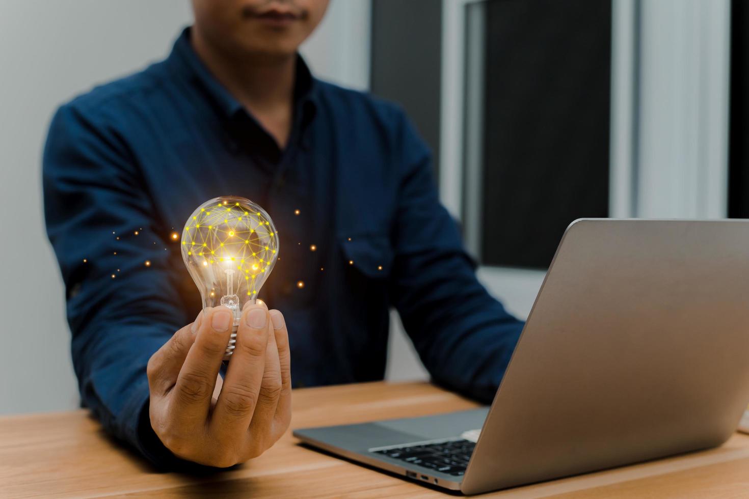 Businessman holding a bright light bulb  Concept of Ideas to present new ideas Great inspiration photo