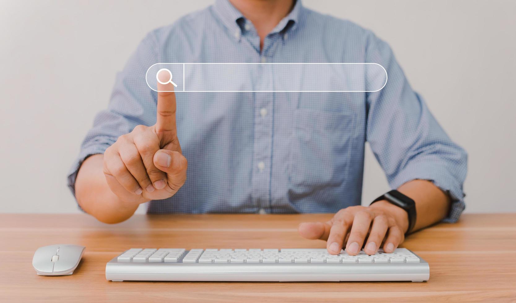 Man's hand pressing a search button photo