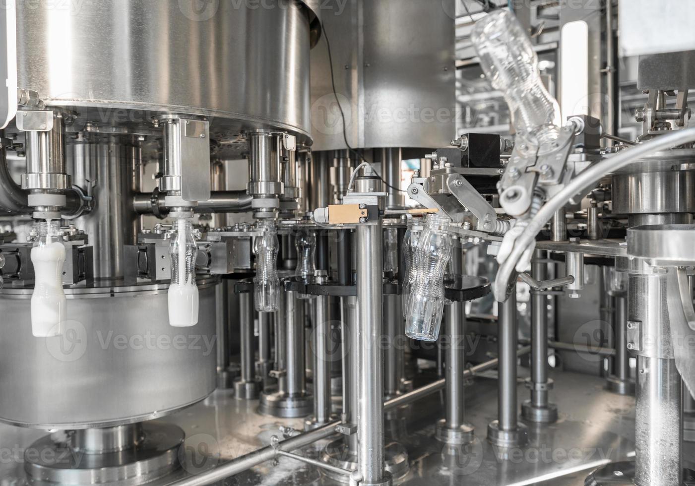 filling milk in to plastic bottles at the factory. equipment at the dairy plant photo