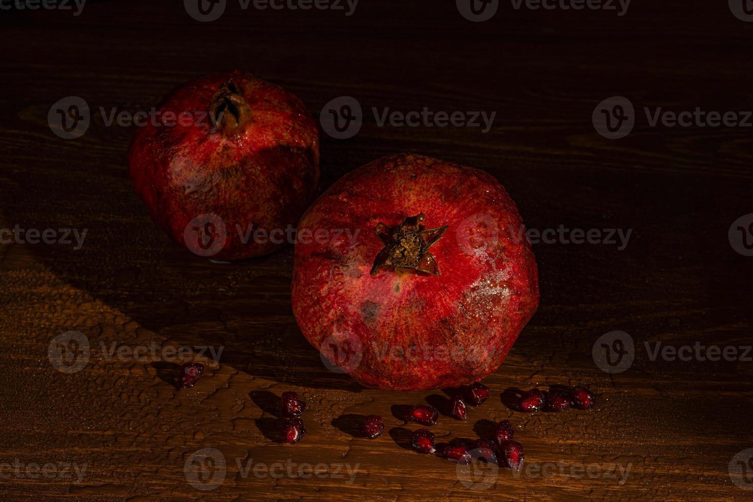 red ripe wet pomegranate on the table. Close-up photo