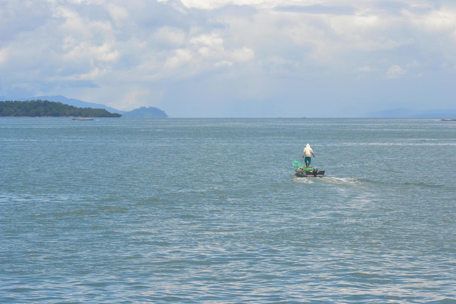 A fisherman working alone at the sea photo