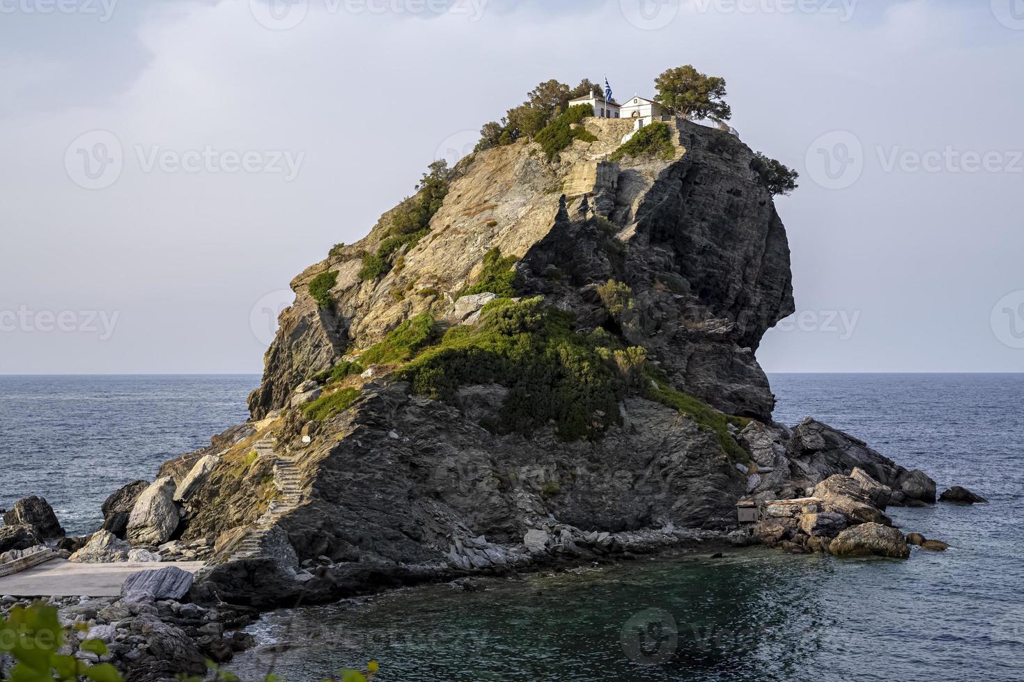 Featured in the hit film musical 'Mama Mia', the chapel of St John the Baptist sits dramatically on the top of a finger of rock off the island of Skopelos in the Aegean sea in Greece. photo