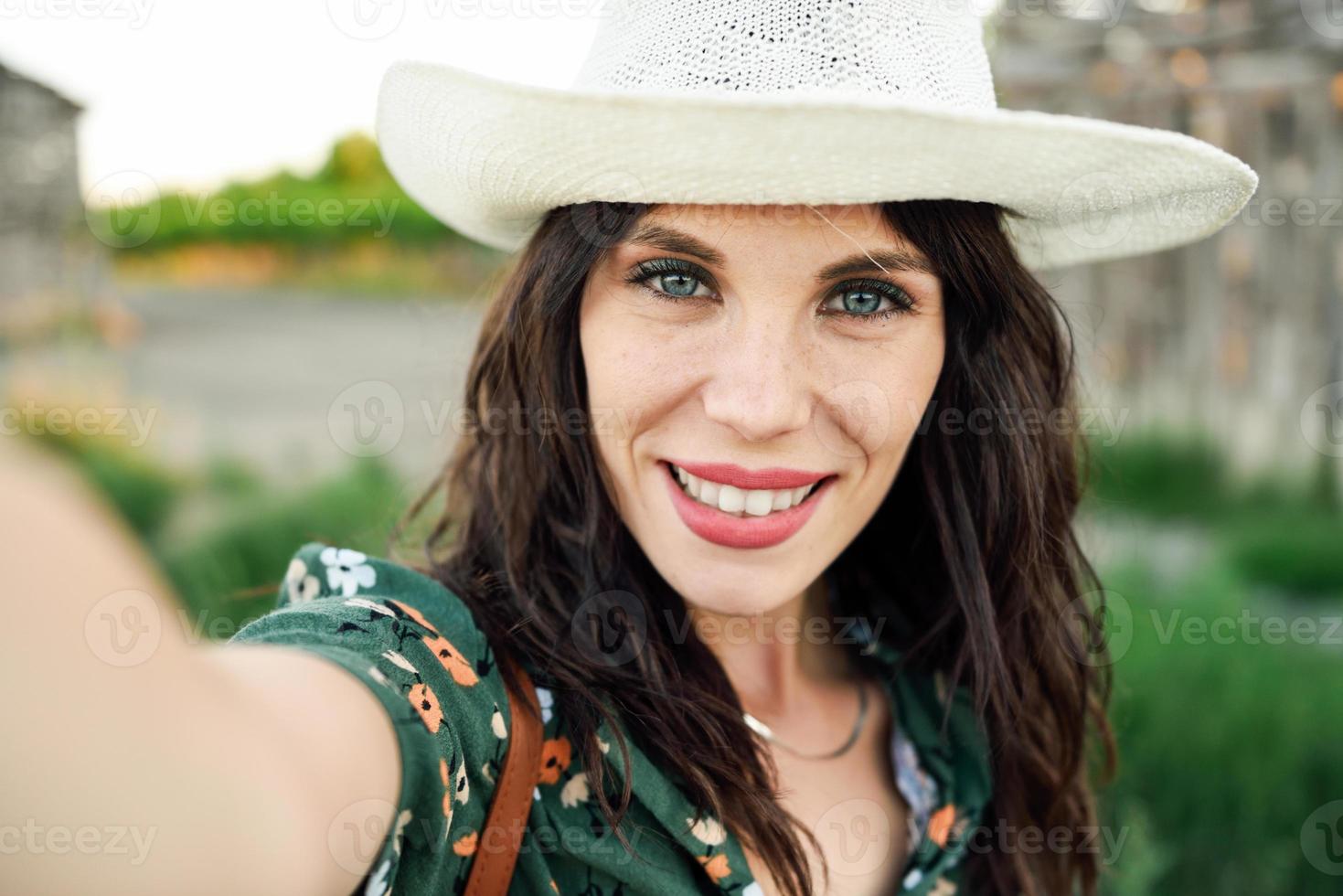 Hiker young woman taking a selfie photograph outdoors photo