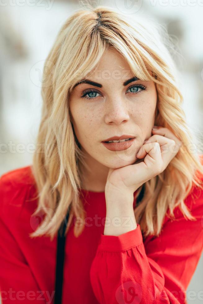 Blonde girl with red shirt enjoying life outdoors. photo