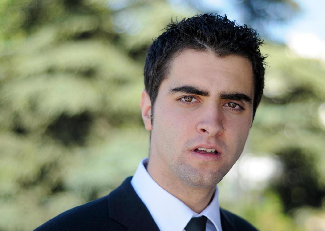 Portrait of a young businessman standing outdoors photo