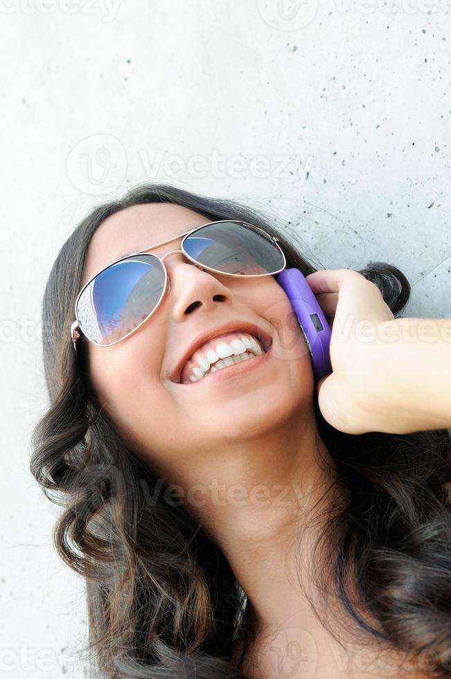 Young beautiful woman talking on phone photo