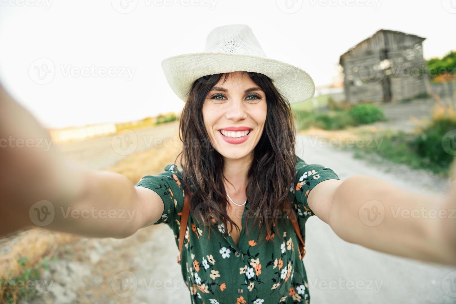 Hiker young woman taking a selfie photograph outdoors photo