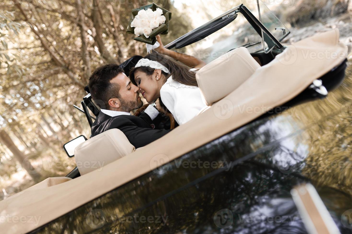 Just married couple in an old car photo