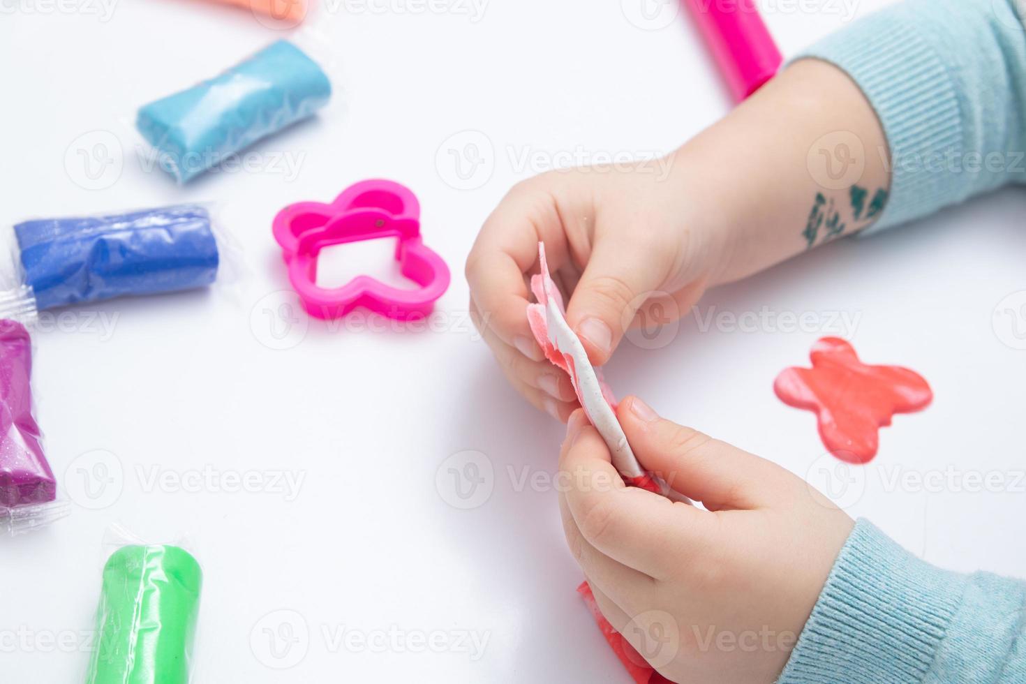 Childrens hands play dough for children's creativity. Board game for the development of fine motor skills photo