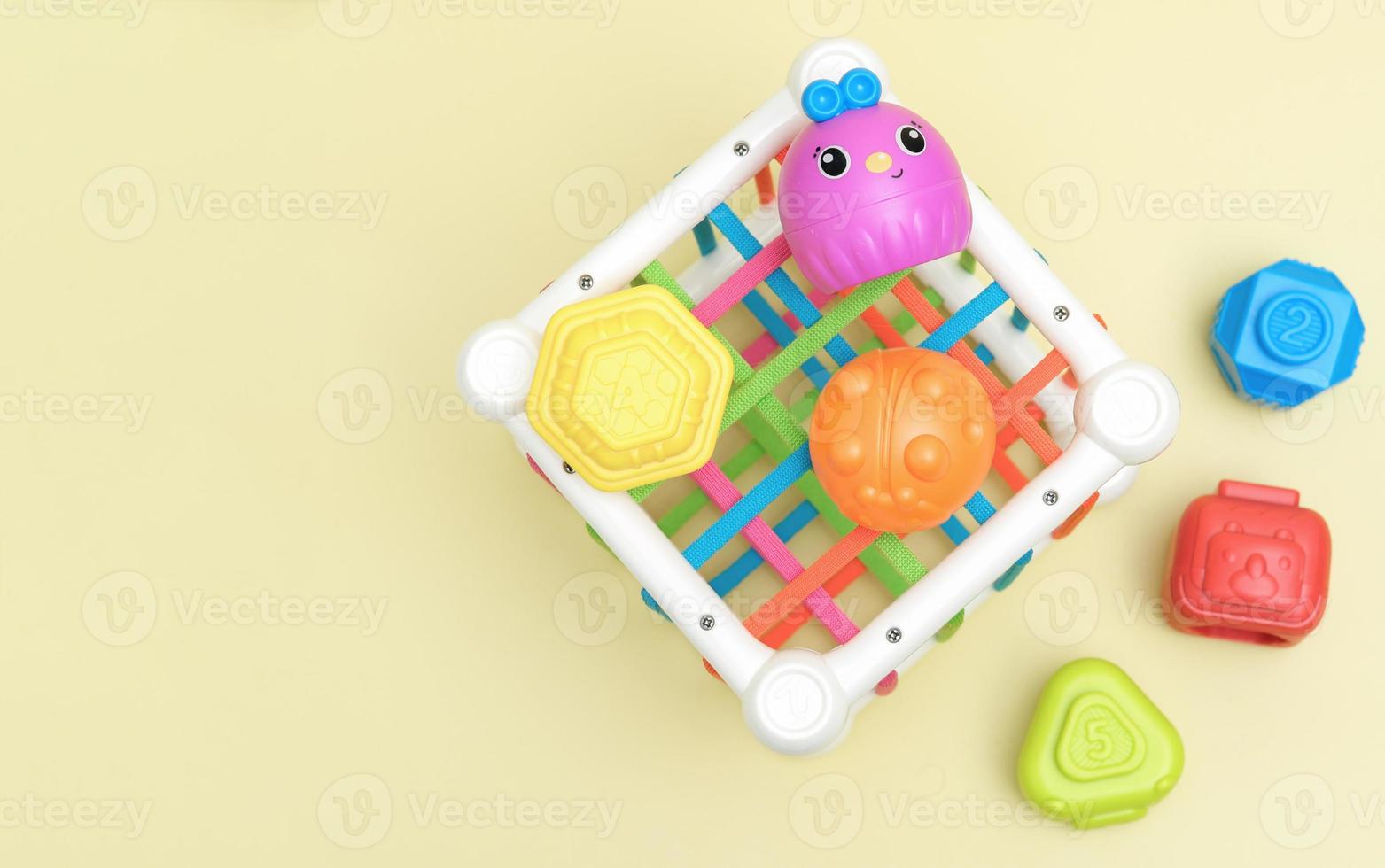 top view of kids educational toy, colorful cube with details for skills developing and brain boost. montessory method photo