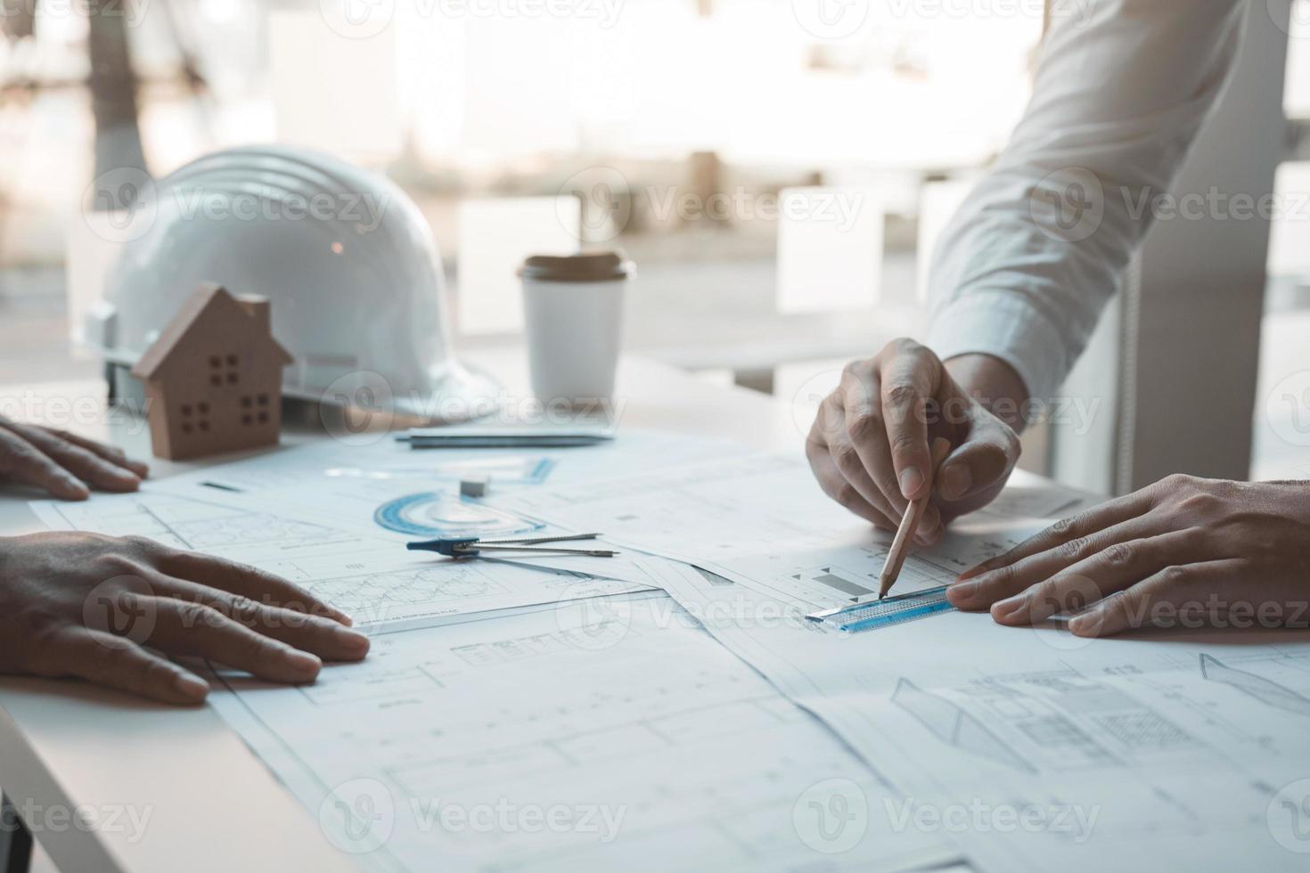 Team architect or engineering people discussion working on table together at a construction site. photo