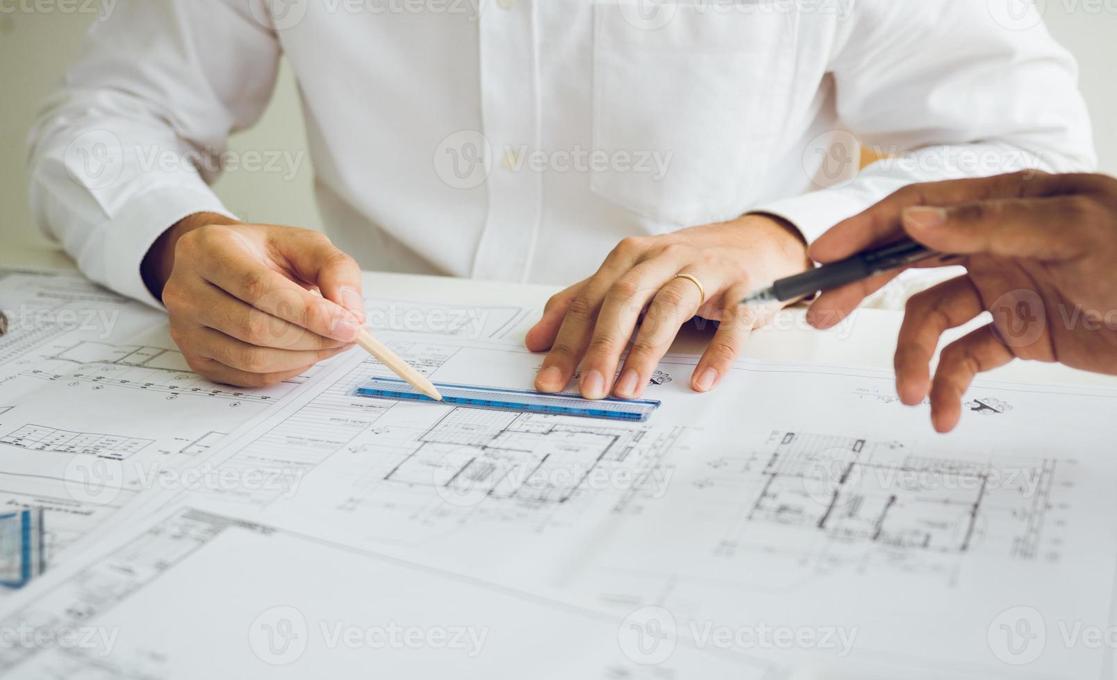 Team architect or engineering people discussion working on table together at a construction site. photo