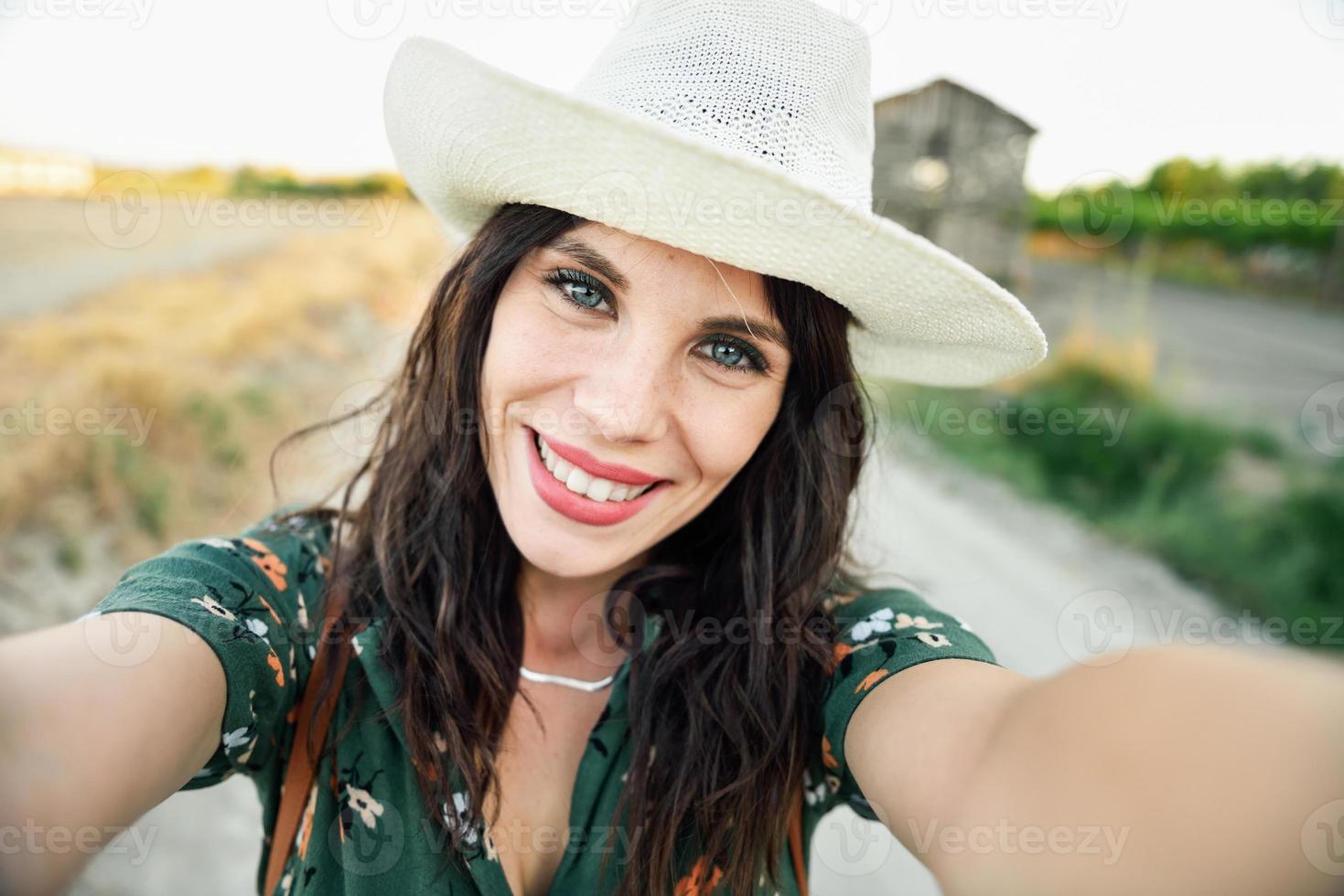 Hiker young woman taking a selfie photograph outdoors photo