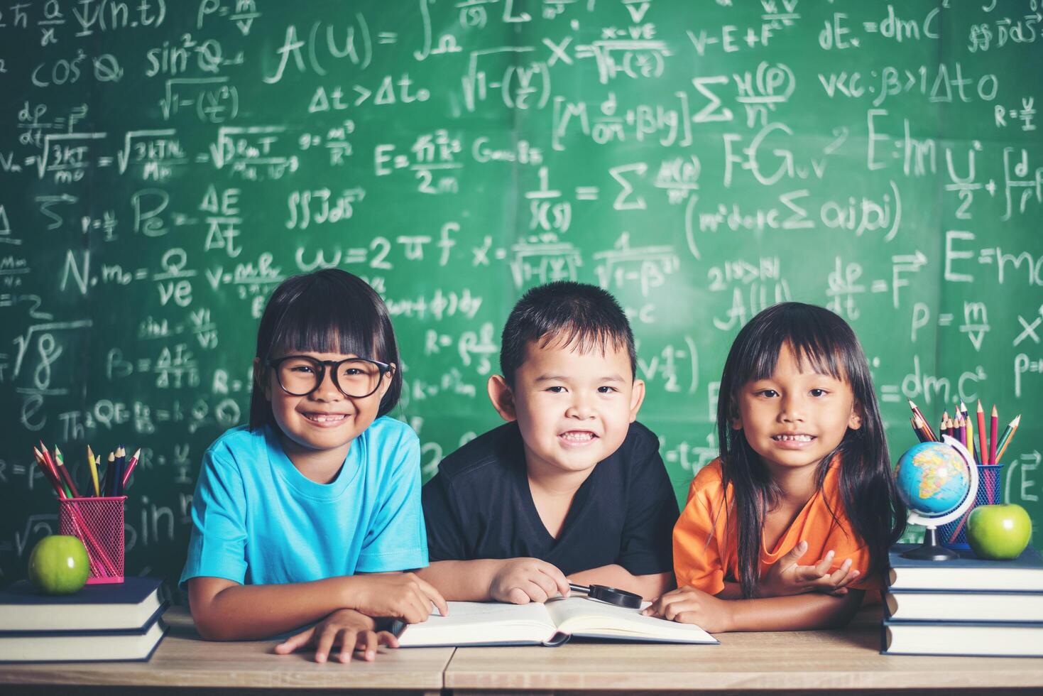 pupils  reading a book in the classroom. photo