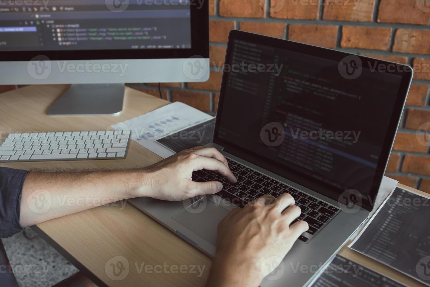 Asian man working code program developer computer web development working design software on desk in office. photo