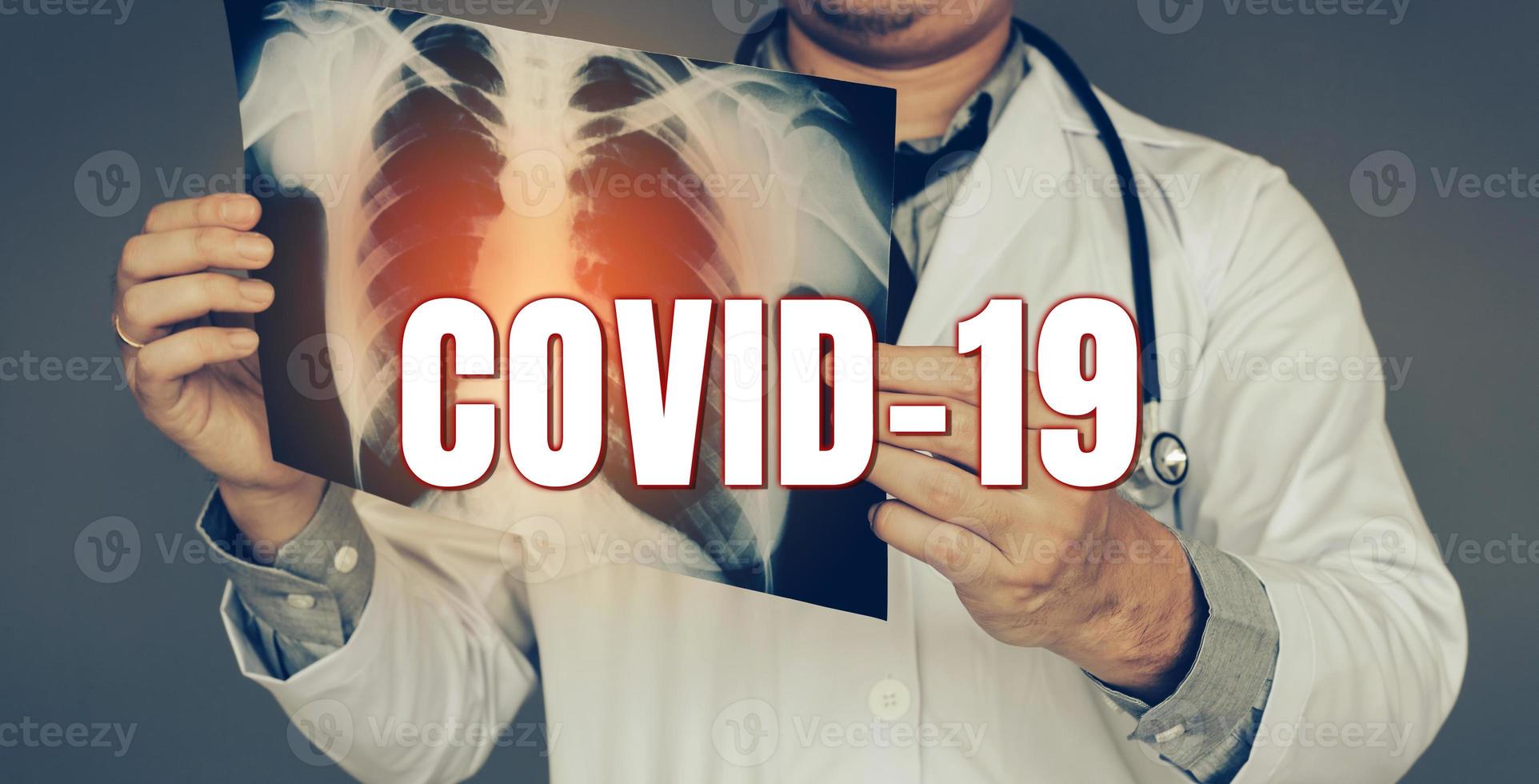 The doctor was carrying an x-ray picture and looking at the lung infection new rapidly spreading Coronavirus Covid-19 concept. photo