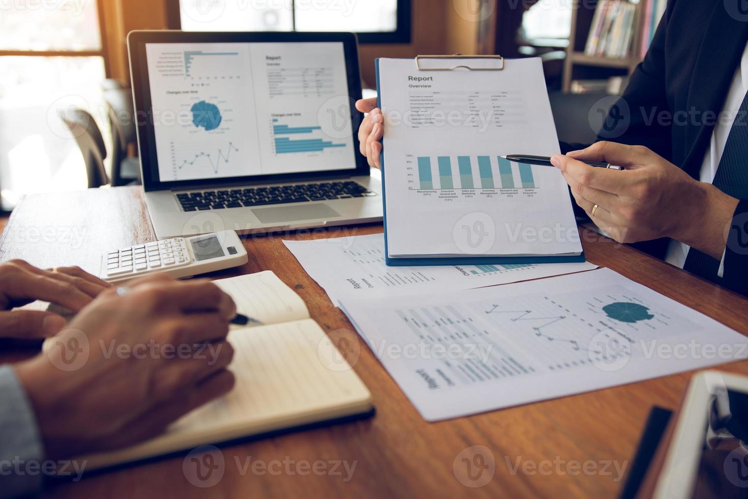 Colleagues are stress talking about the finance results report and compared with the financial information on the paperwork with analysis about planning in the future. photo