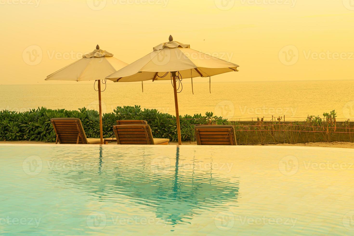 umbrella with bed pool around swimming pool with ocean sea background