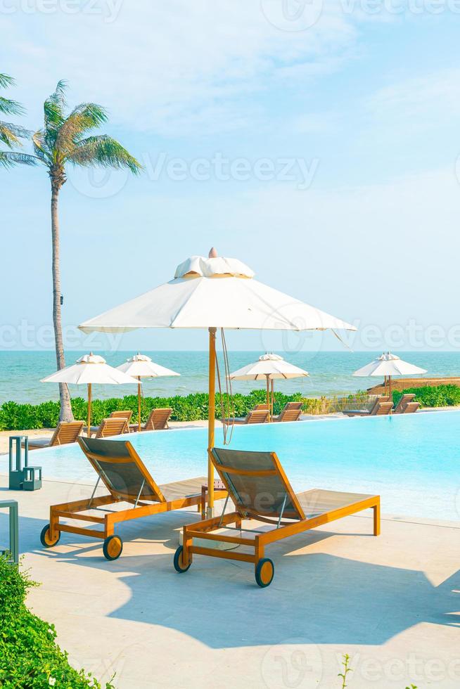 umbrella with bed pool around swimming pool with ocean sea background