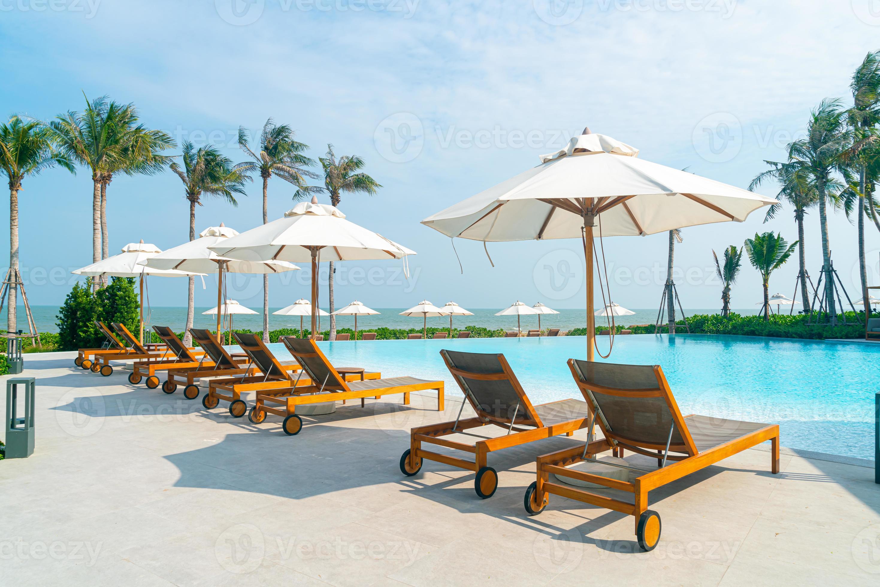 umbrella with bed pool around swimming pool with ocean sea background