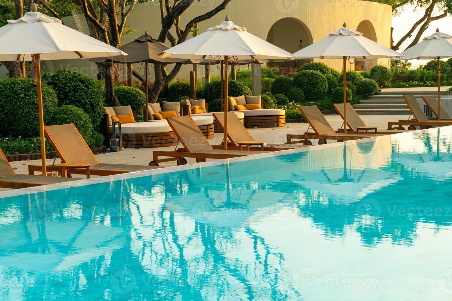 umbrella with bed pool around swimming pool with ocean sea background