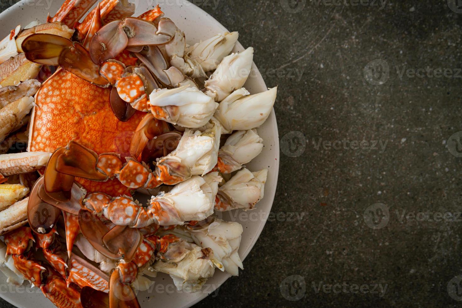 Steamed blue crab with spicy seafood sauce photo
