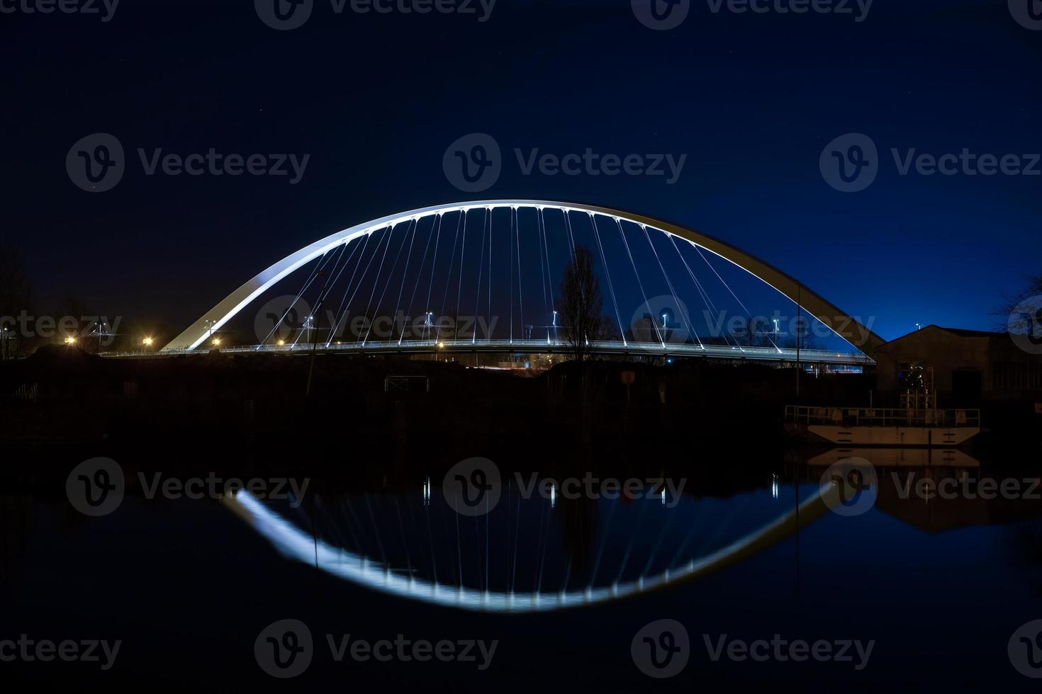 Citadelle Bridge across Bassin Vauban for trams and bicycles. Night view. photo
