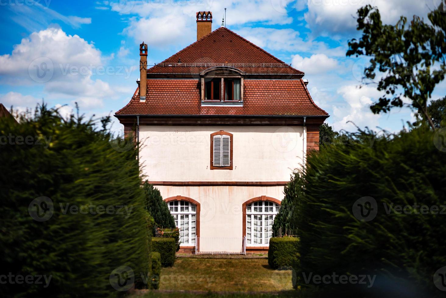 Alsace's sun-drenched gingerbread houses. Tiled roofs, flowers all around, the summer sun is shining. Beauty. photo