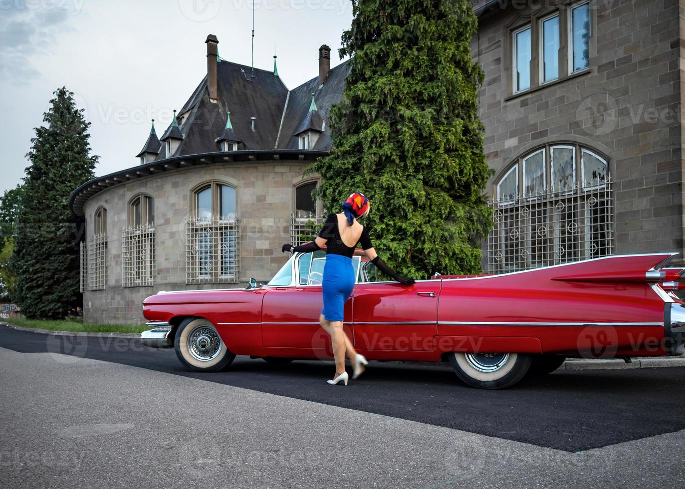 Old-timer red Cadillac and a beautiful young girl photo