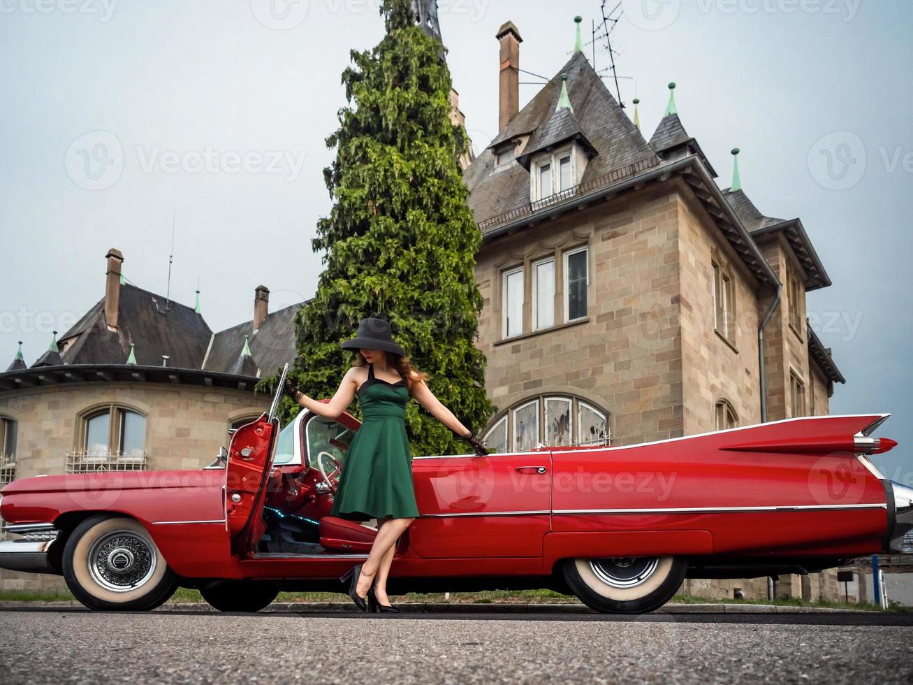 Old-timer red Cadillac and a beautiful young girl photo