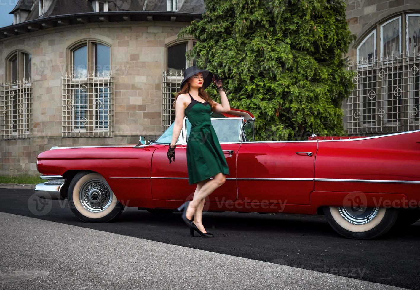 Old-timer red Cadillac and a beautiful young girl photo