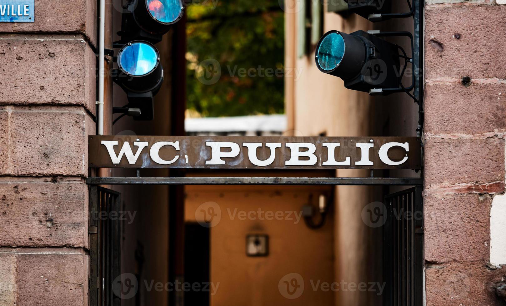 Sign of a public restroom in Ribeauville main square photo