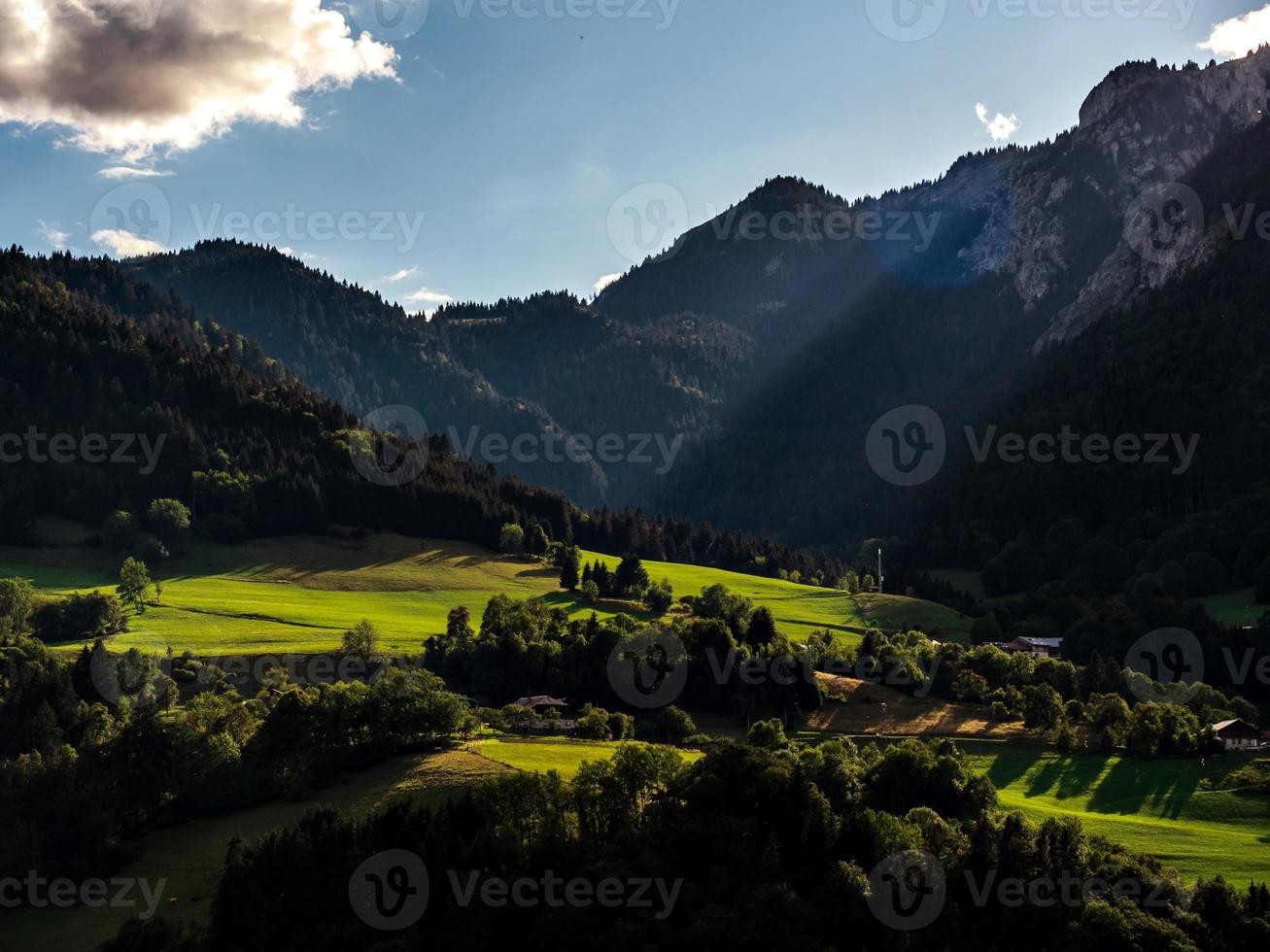 Panoramic view of alpine meadows and rocks in sunset evening lighting photo