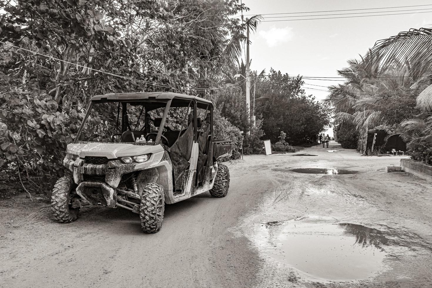 Buggy car golf cart carts muddy street village Holbox Mexico. photo