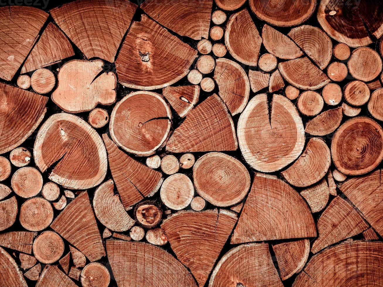 A repeating rhythmic background made from pieces of sawn wood. Background for design. photo