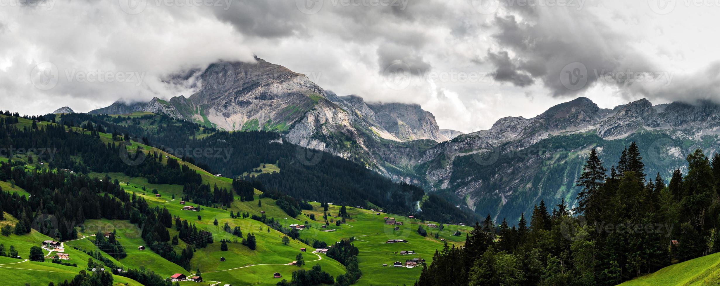 Terrible lifeless rocks, a glacier in the Alps, clouds and fog spread over the peaks of the mountains photo