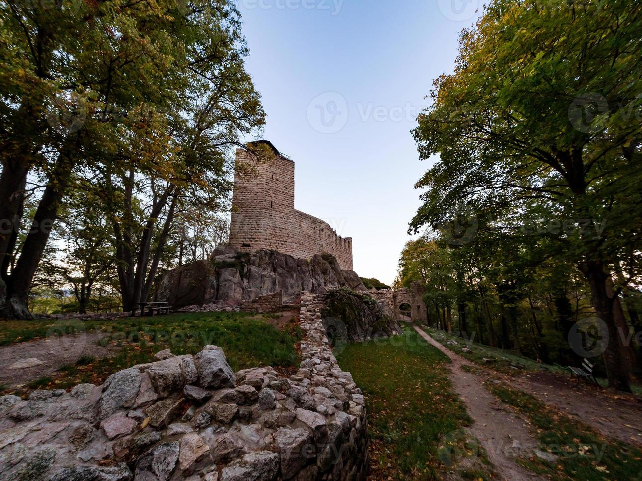 Old medieval hilltop castle Bernstein in Alsace. The ruins of a historic fort are built on a cliff. photo