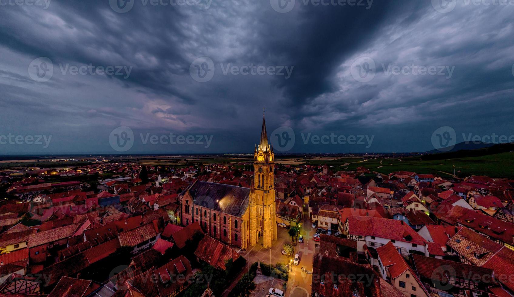 Aerial drone panoramic view of night highlighted village Dambach-la-Ville in Alsace. photo