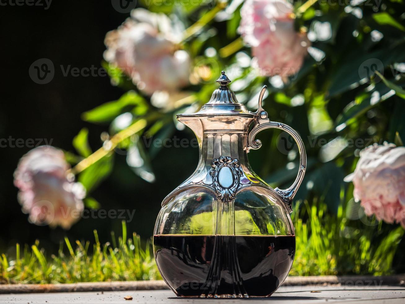 Wine jug made of crystal and silver. Antique item for the table. Elegant rich dishes for decorating a feast. photo